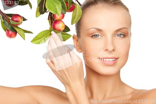 Image of lovely woman with apple twig