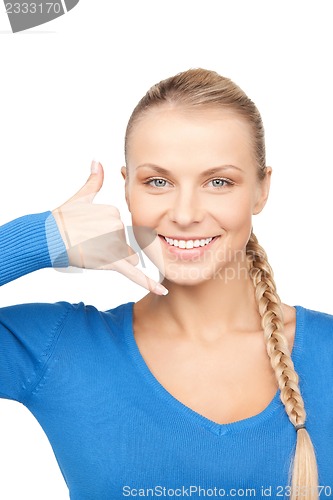 Image of woman making a call me gesture