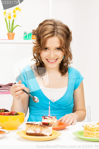 Image of lovely housewife with cake and candle