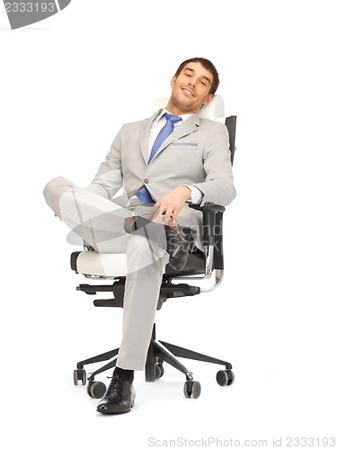 Image of young businessman sitting in chair
