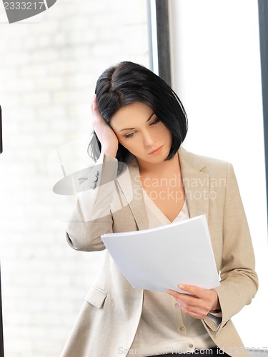 Image of calm woman with documents