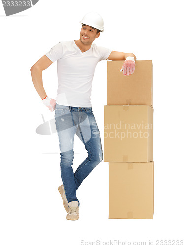 Image of handsome builder with big boxes