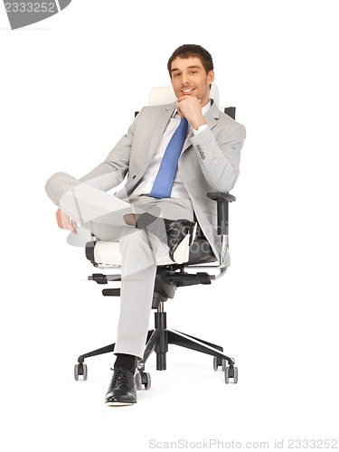 Image of young businessman sitting in chair