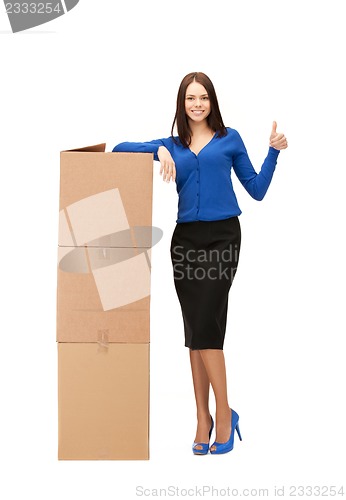 Image of attractive businesswoman with big boxes