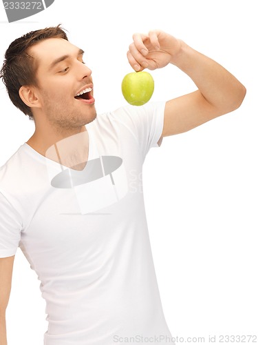 Image of man in white shirt with green apple