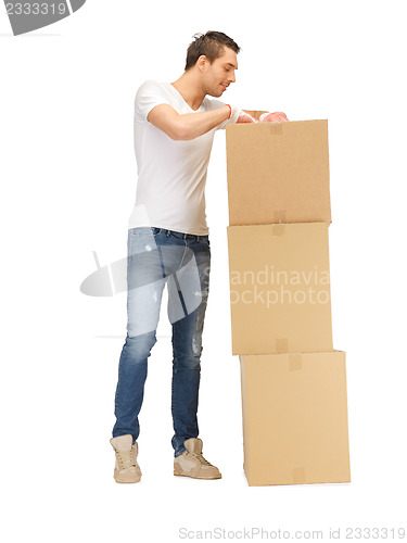 Image of handsome man with big boxes