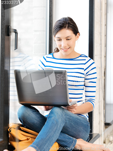 Image of happy teenage girl with laptop computer