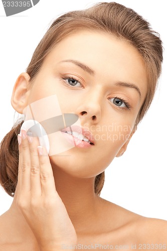 Image of beautiful woman with cotton pad