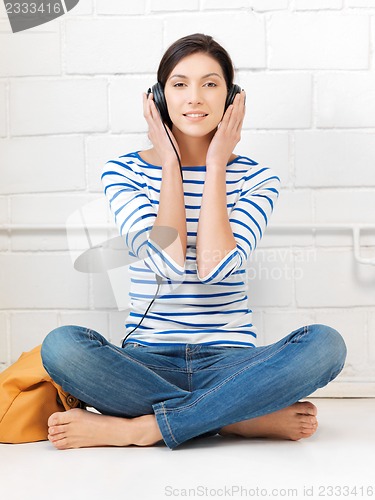 Image of happy teenage girl in big headphones