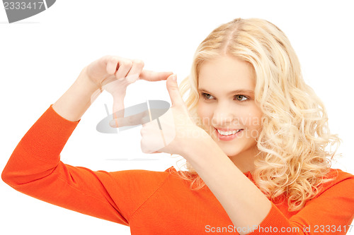 Image of lovely woman creating a frame with fingers