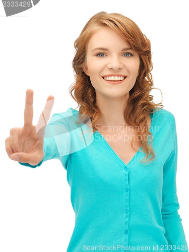 Image of teenage girl showing victory sign