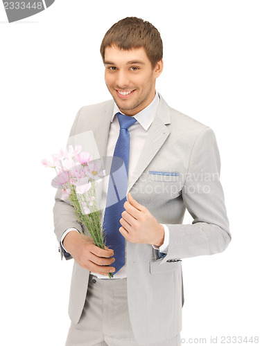 Image of handsome man with flowers in hand