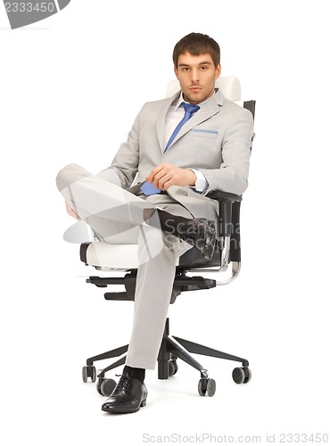 Image of young businessman sitting in chair