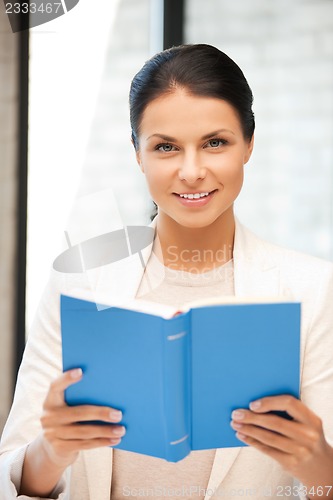 Image of happy and smiling woman with book