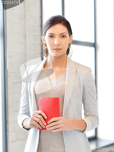 Image of calm and serious woman with book