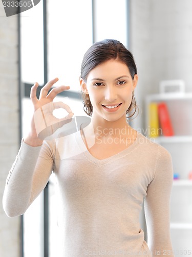 Image of lovely teenage girl showing ok sign