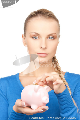 Image of lovely woman with piggy bank and money