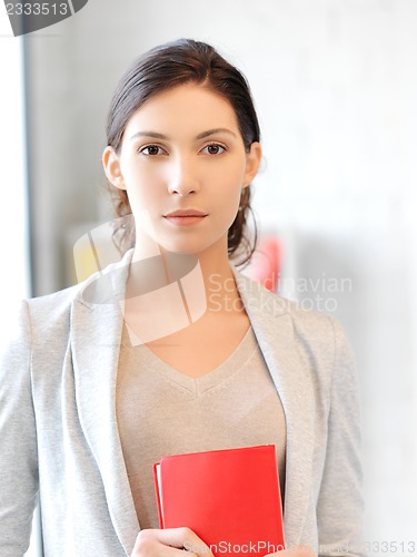 Image of calm and serious woman with book