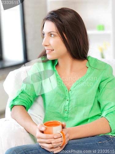 Image of happy woman with mug