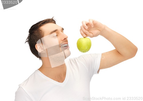 Image of man in white shirt with green apple