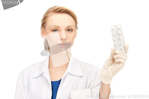 Image of attractive female doctor with pills