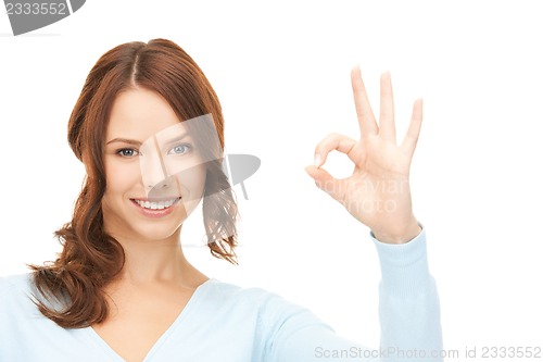 Image of lovely teenage girl showing ok sign