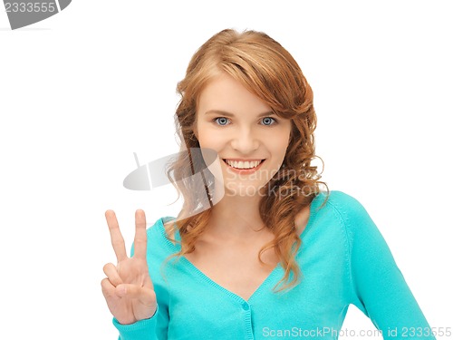 Image of teenage girl showing victory sign