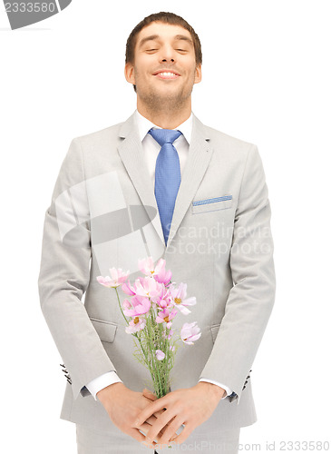 Image of handsome man with flowers in hand