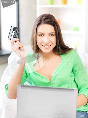 Image of happy woman with laptop computer and credit card