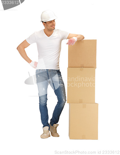 Image of handsome builder with big boxes