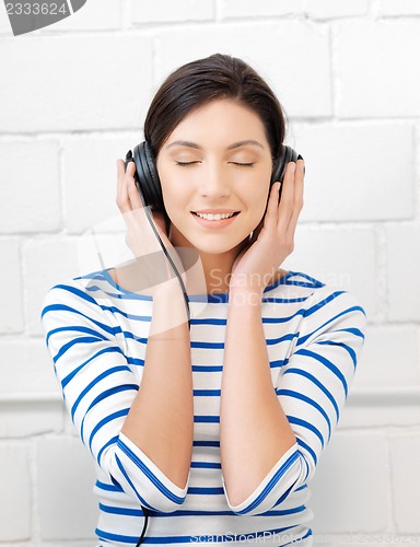 Image of happy teenage girl in big headphones