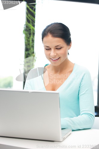 Image of happy woman with laptop computer