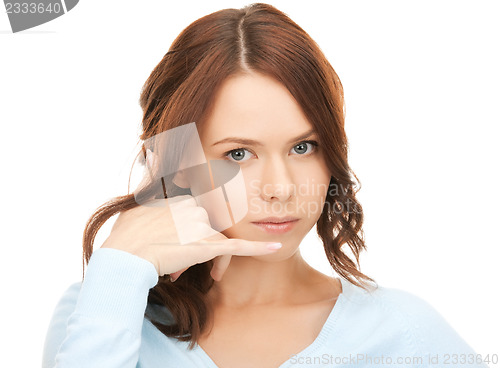 Image of woman making a call me gesture