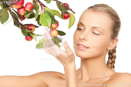 Image of lovely woman with apple twig