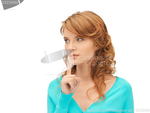 Image of teenage girl with finger on lips