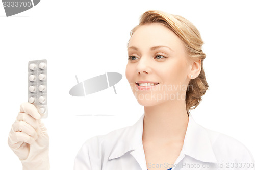 Image of attractive female doctor with pills