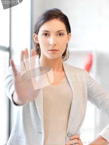 Image of young woman making stop gesture