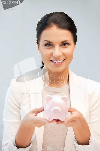 Image of lovely woman with piggy bank