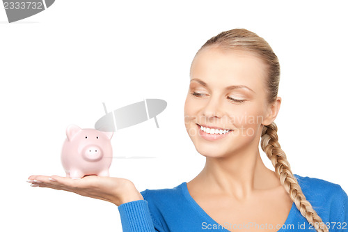 Image of lovely woman with piggy bank