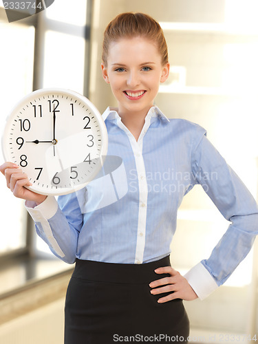 Image of attractive businesswoman with clock