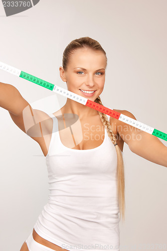 Image of young beautiful woman with measure tape