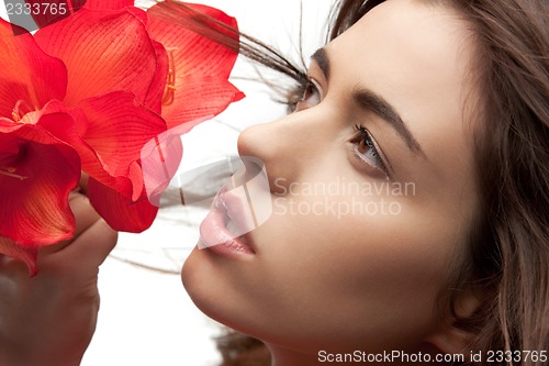 Image of lovely woman with red flowers