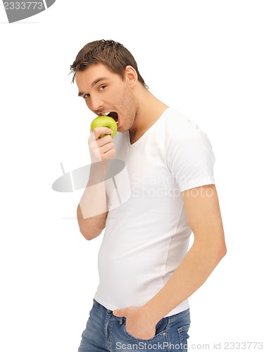Image of man in white shirt with green apple