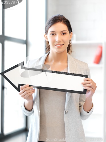 Image of businesswoman with direction arrow sign