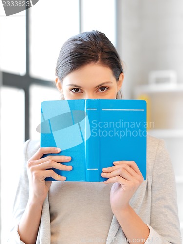 Image of calm and serious woman with book