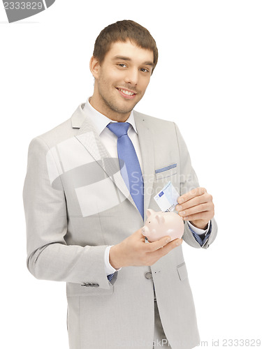 Image of man with piggy bank and money