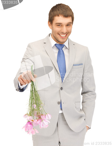 Image of handsome man with flowers in hand