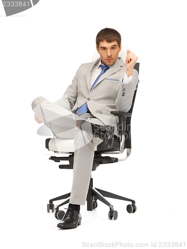 Image of young businessman sitting in chair