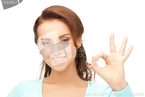 Image of lovely teenage girl showing ok sign