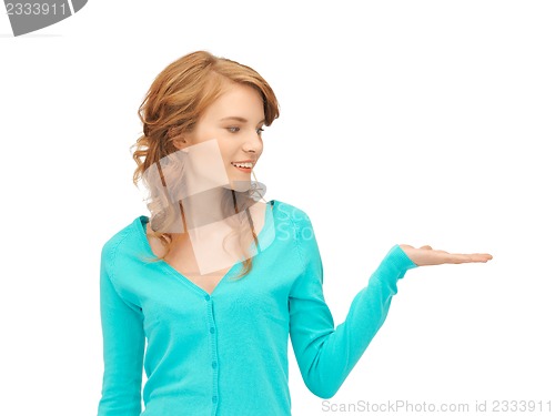 Image of girl showing something on the palm of her hand